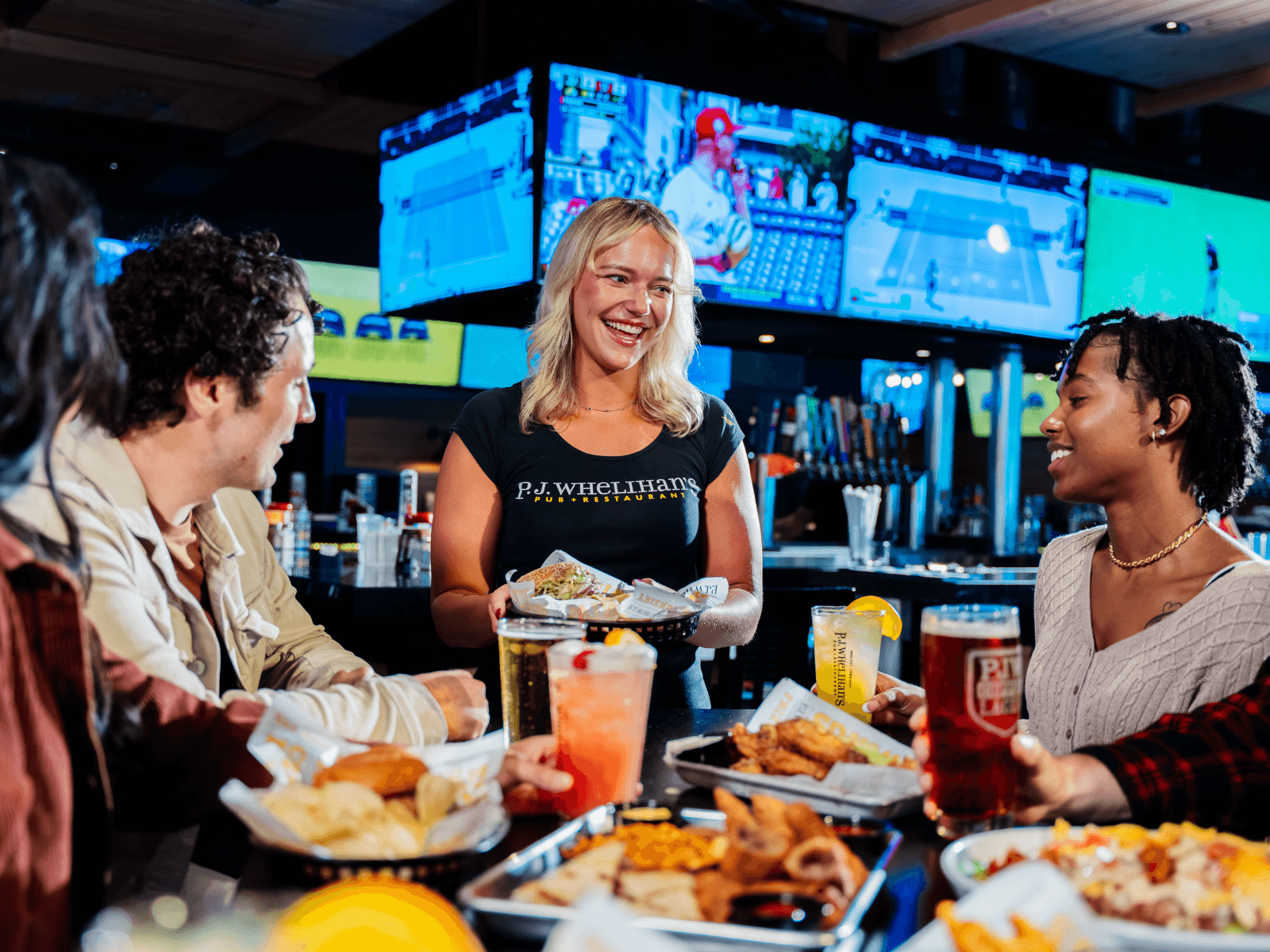 PJ's Pub waitress serving a group of patrons. 